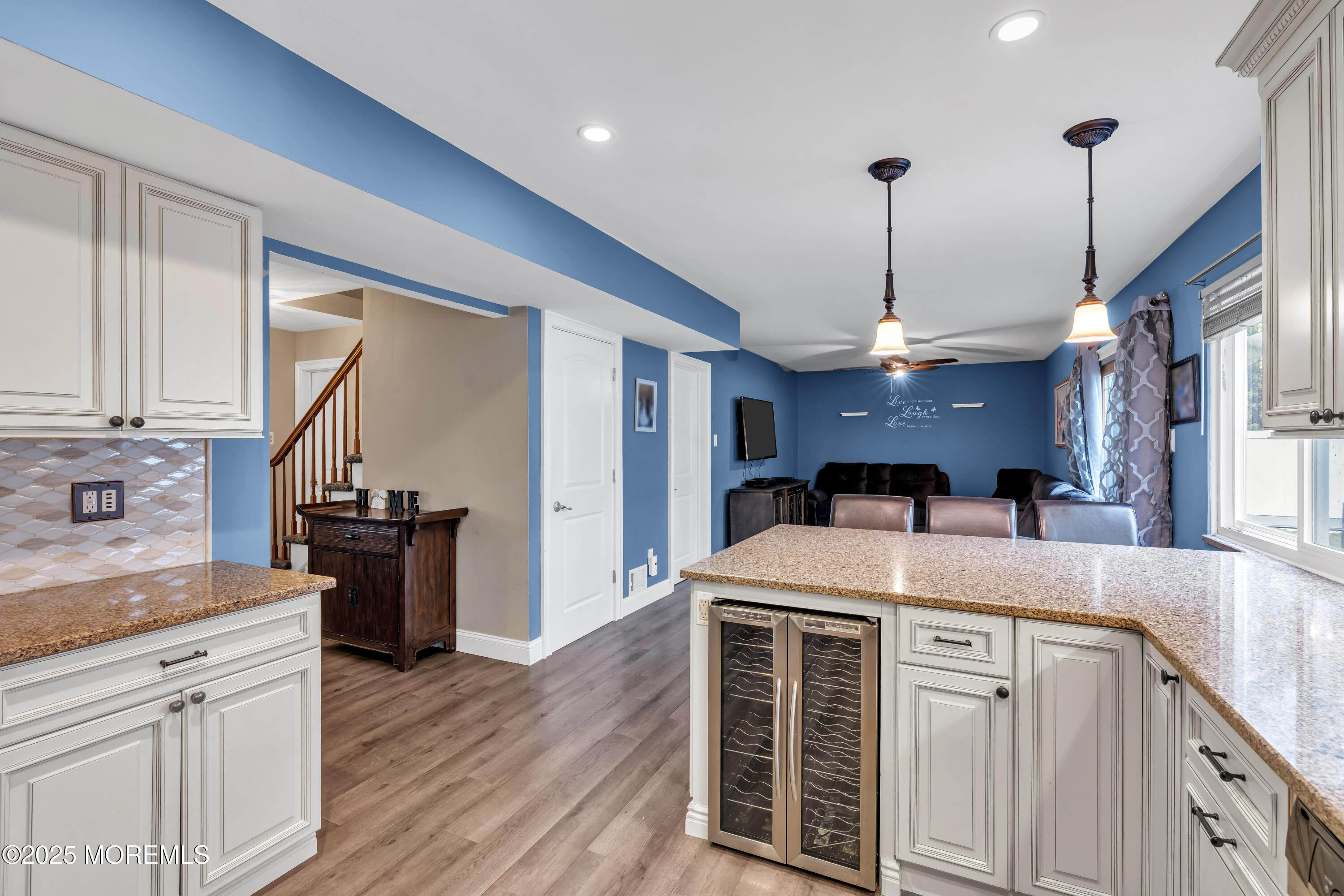36 Appletree Road Howell, NJ 07731 - Photo 16 of 38 a kitchen with a stove a sink a center island and wooden floor
