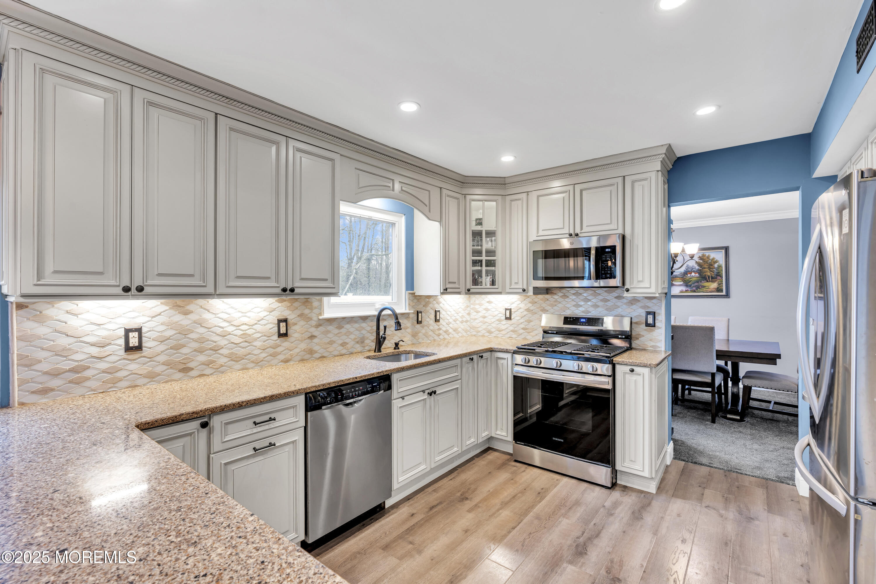 36 Appletree Road Howell, NJ 07731 - Photo 17 of 38 a kitchen with stainless steel appliances granite countertop a sink stove and refrigerator