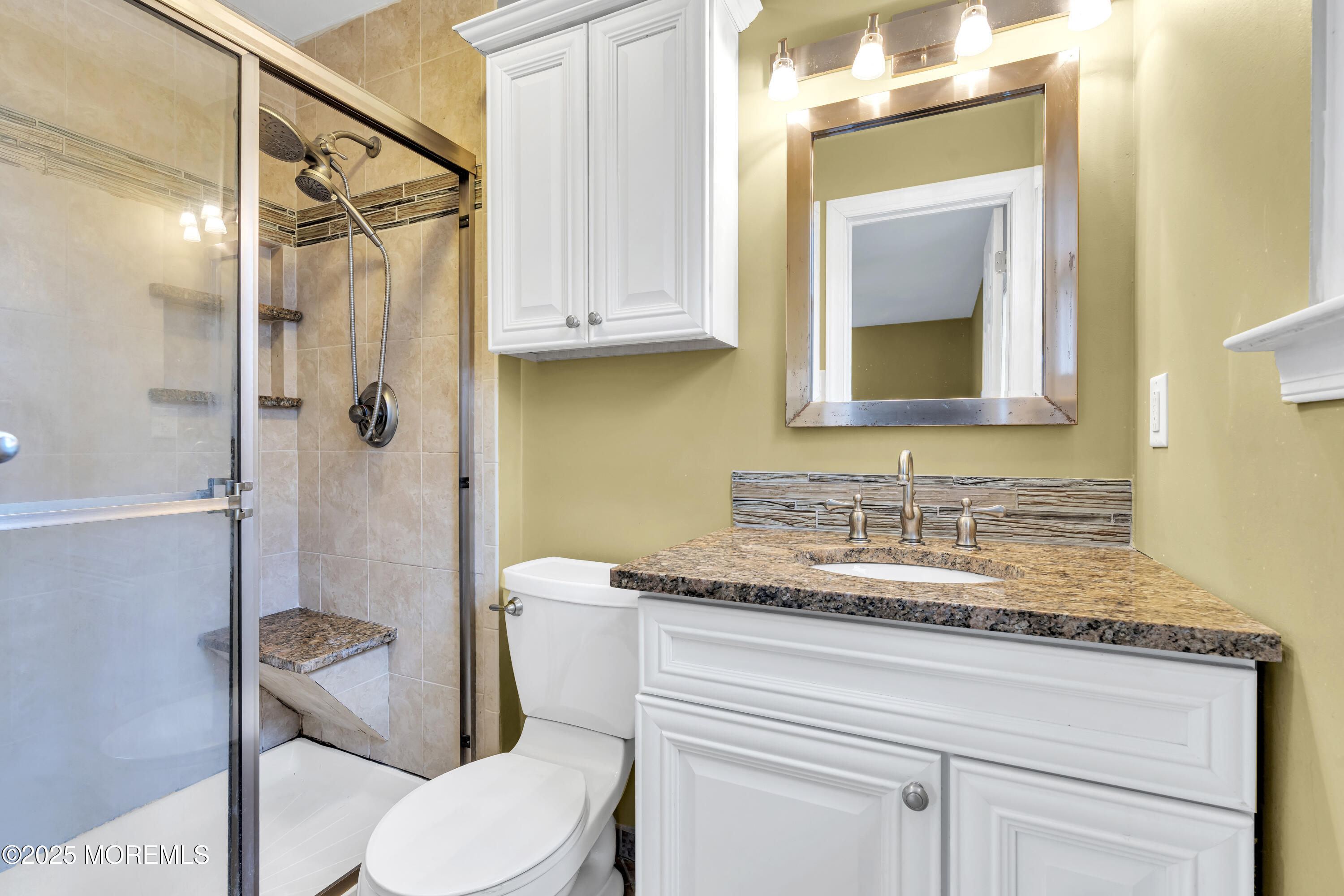 36 Appletree Road Howell, NJ 07731 - Photo 28 of 38 a bathroom with a granite countertop sink toilet mirror and a shower