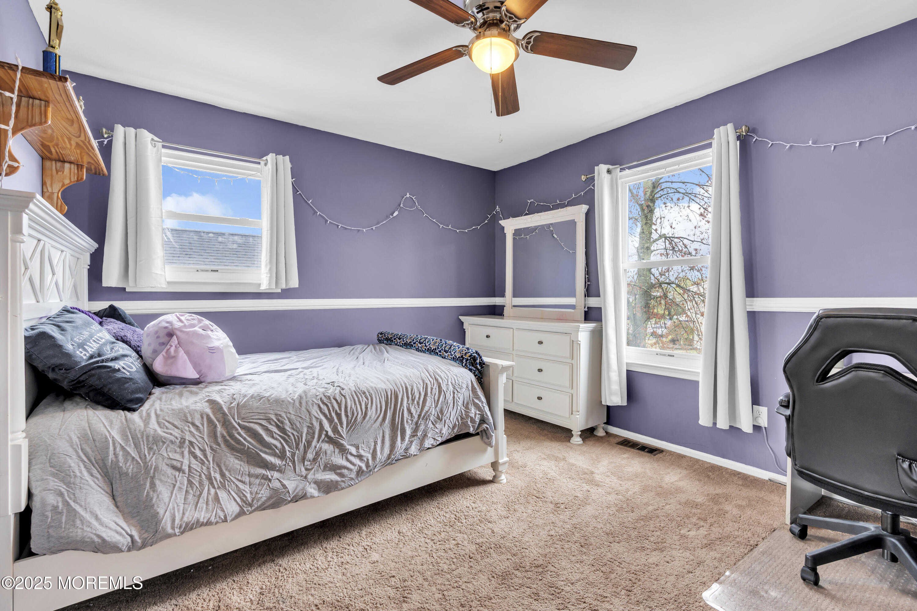 36 Appletree Road Howell, NJ 07731 - Photo 29 of 38 a bedroom with a large bed and a chandelier