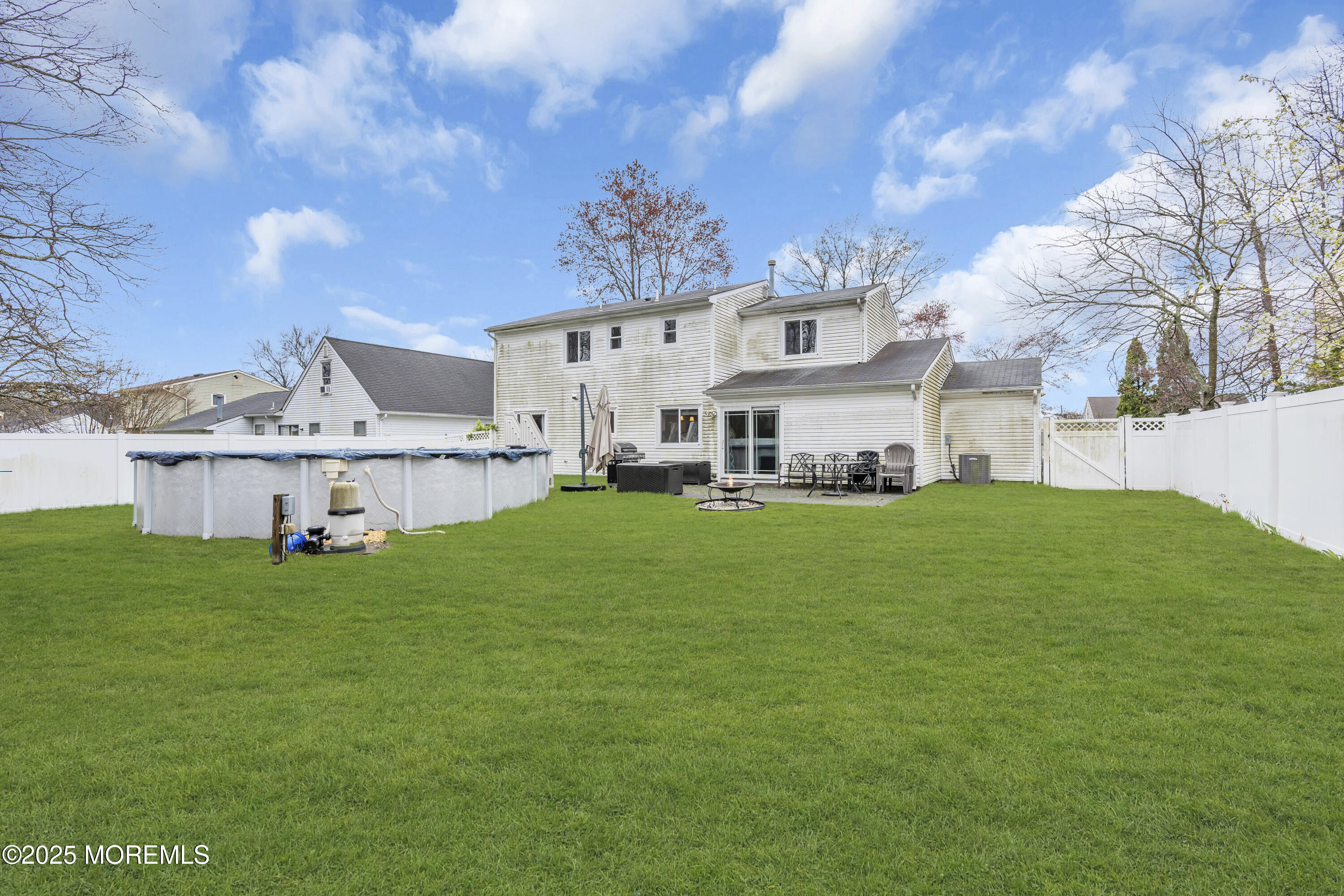 36 Appletree Road Howell, NJ 07731 - Photo 36 of 38 a view of a white house in front of a big yard with plants and large trees