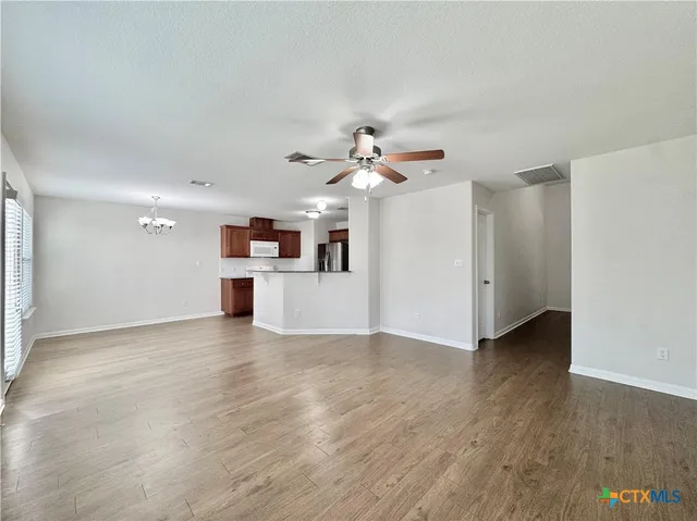a view of a kitchen with a dishwasher cabinets and wooden floor