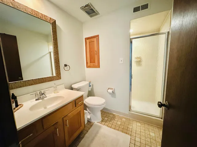 a bathroom with a sink and mirror with toilet