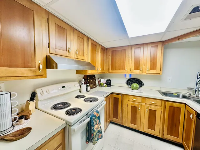 a kitchen with a sink a stove and cabinets