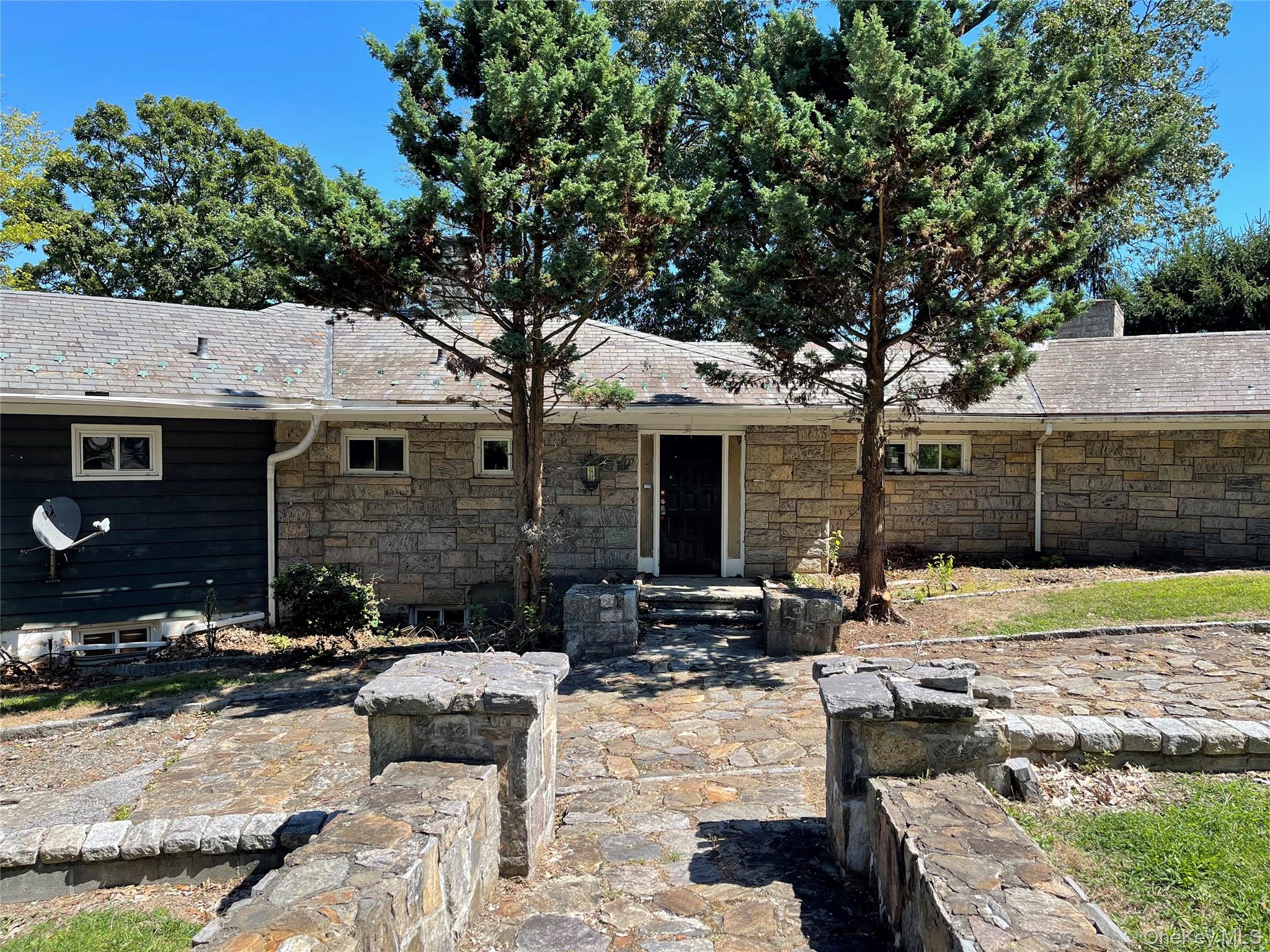 Front view of property with stone siding