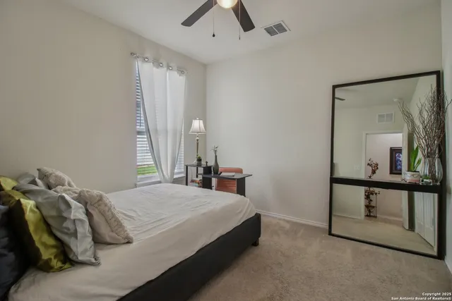 a bedroom with a bed and a mirror