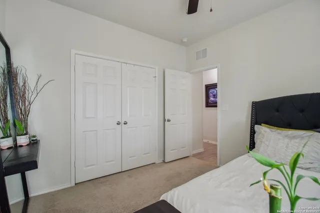 a bedroom with furniture and a potted plant