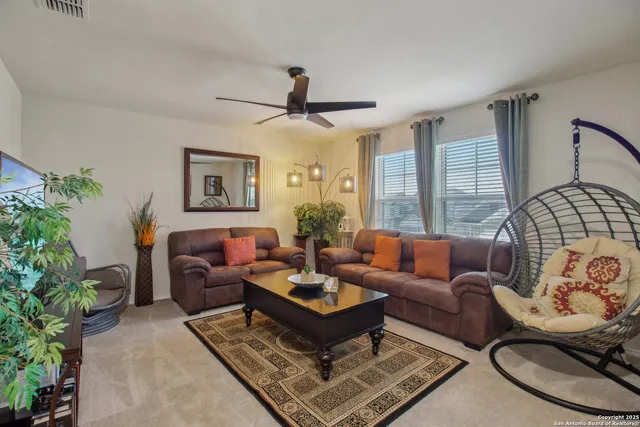 a living room with furniture potted plant and a window