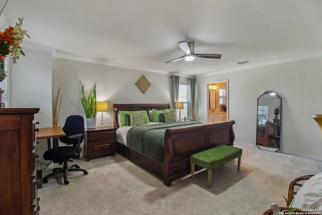 a bedroom with a bed a chair and a chandelier