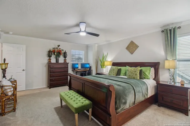 a bedroom with a bed chandelier and a window
