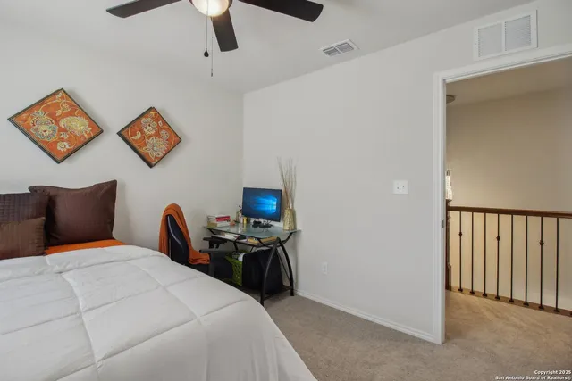 a bedroom with a bed and a lamp on the dresser