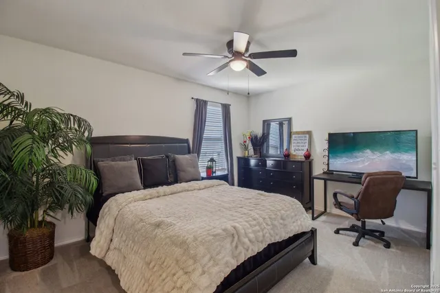 a bedroom with a bed a desk and chair