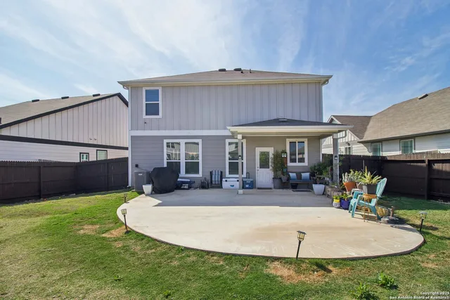 a view of a house with backyard sitting area and porch