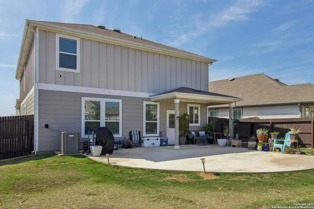 a view of a house with a garden and patio