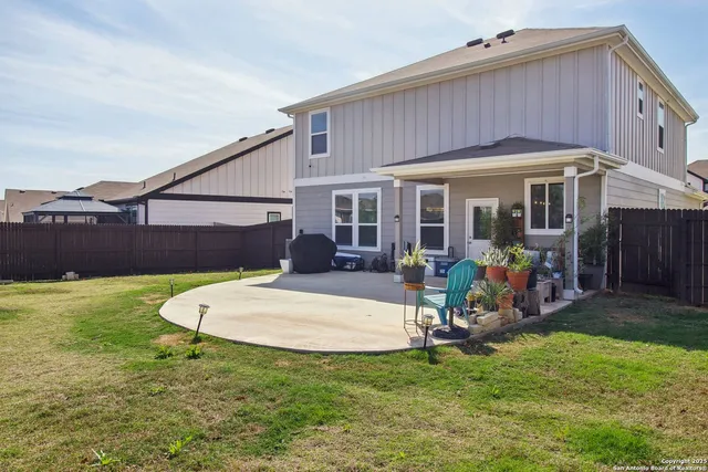 a view of a house with a backyard and porch