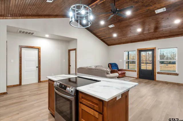 a kitchen with stainless steel appliances granite countertop a refrigerator and a sink