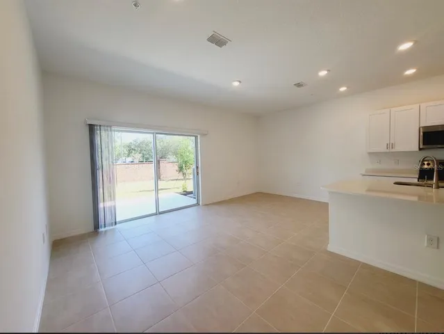 a view of a kitchen with a sink and a window
