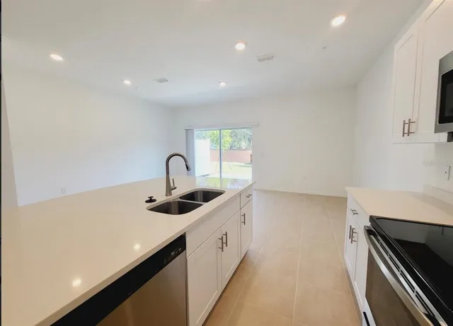 a kitchen with a sink and cabinets