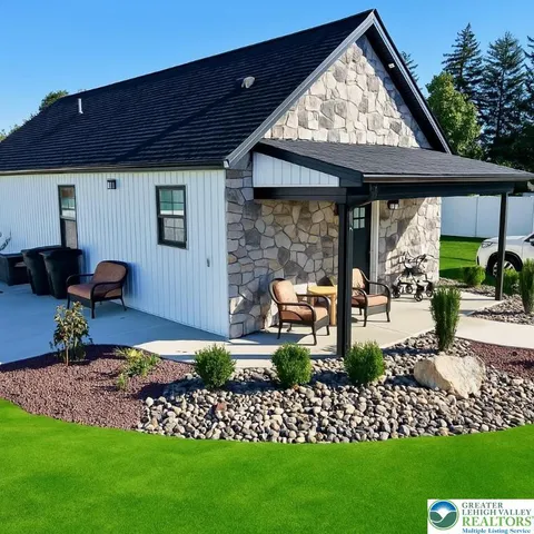 a front view of a house with garden