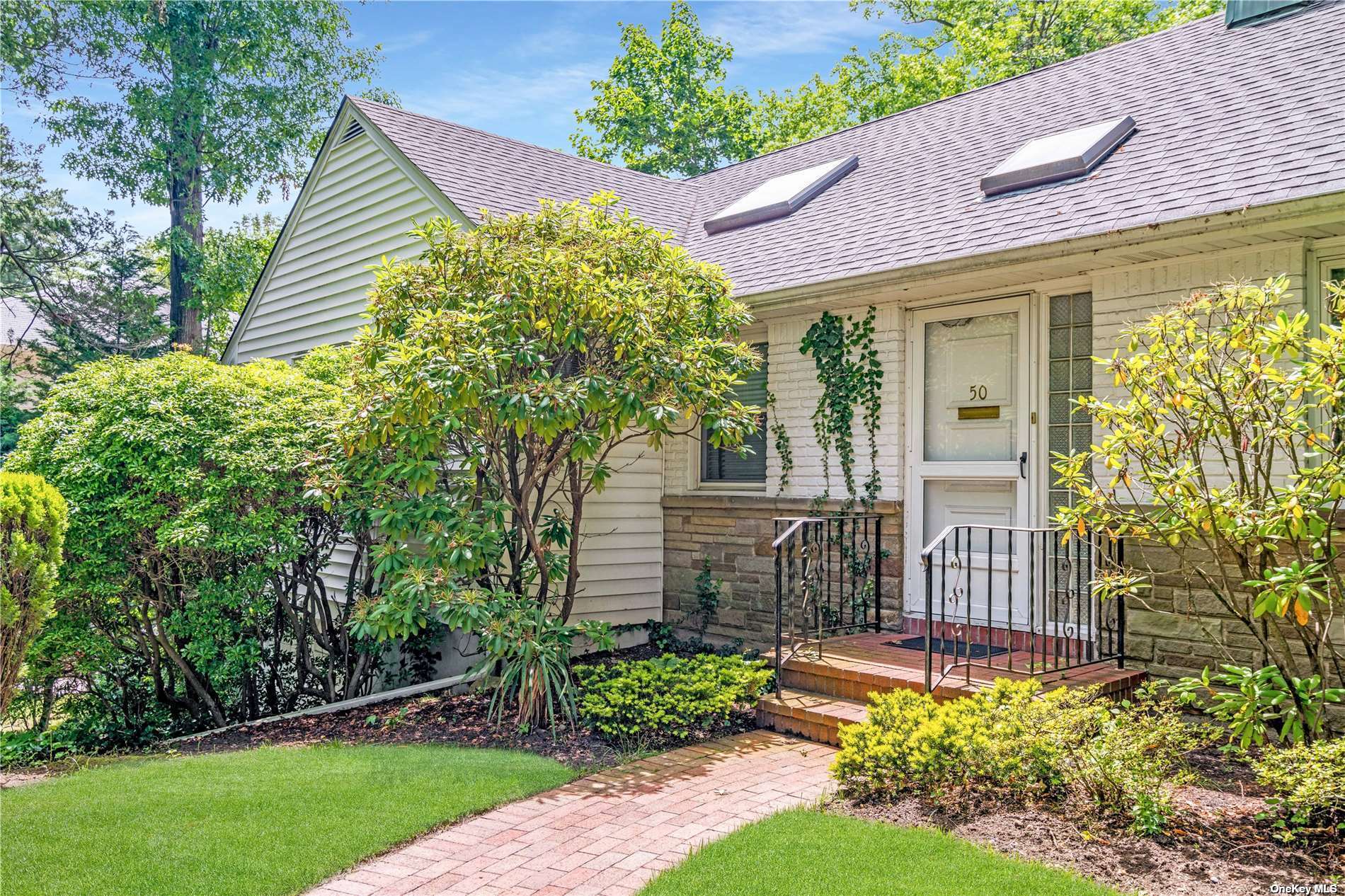 a front view of a house with garden