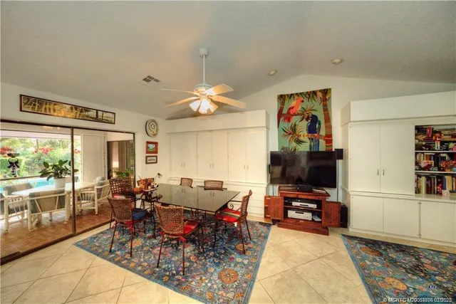 a living room with furniture a rug and a flat screen tv