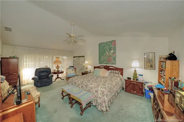 a bedroom with furniture and a flat screen tv