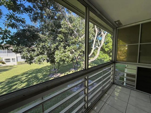 a view of a room with wooden floor and outdoor space