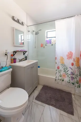 a bathroom with a sink a toilet and bathtub
