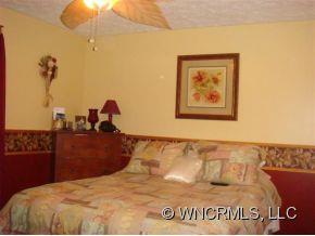 366 Baber Road Rutherfordton, NC 28139 - Photo 4 of 11 a bedroom with a bed and a painting on the wall