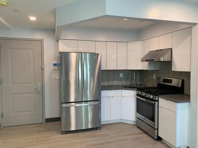 a kitchen with stainless steel appliances a refrigerator stove and sink