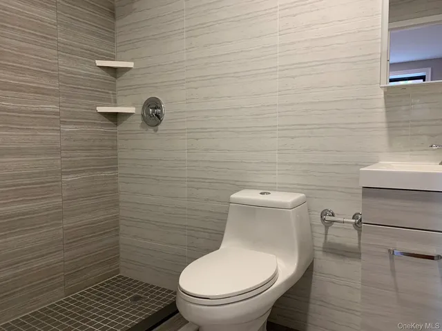 a white toilet sitting next to a bathroom sink