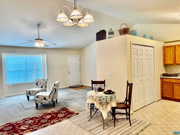 a living room with furniture chandelier and a fireplace