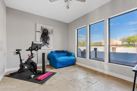 a view of gym equipment with a view of living room