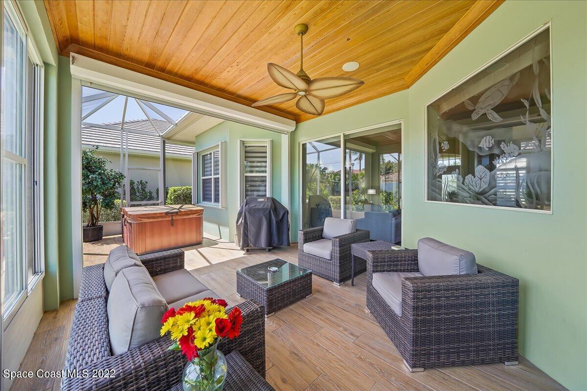 245 Clyde Street Melbourne Beach, FL 32951 - Photo 16 of 47 a living room with furniture a rug and a large window