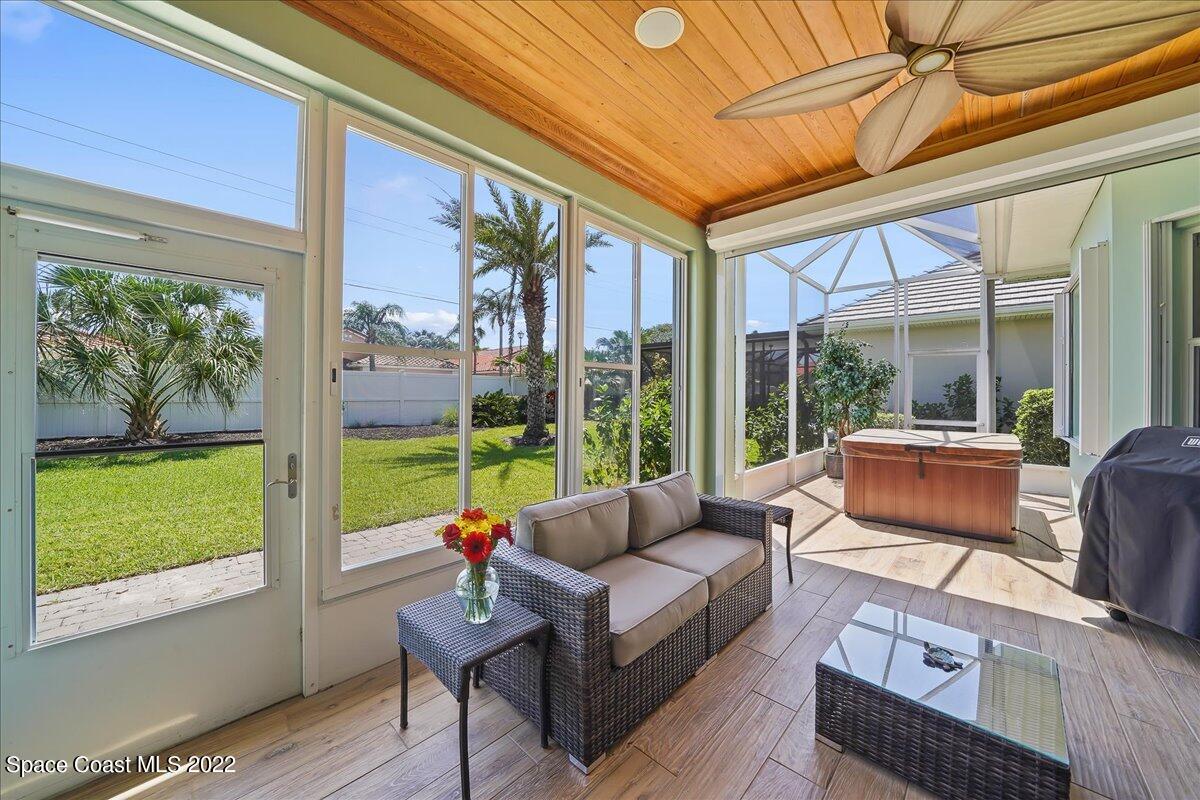 245 Clyde Street Melbourne Beach, FL 32951 - Photo 17 of 47 a living room with furniture and a floor to ceiling window