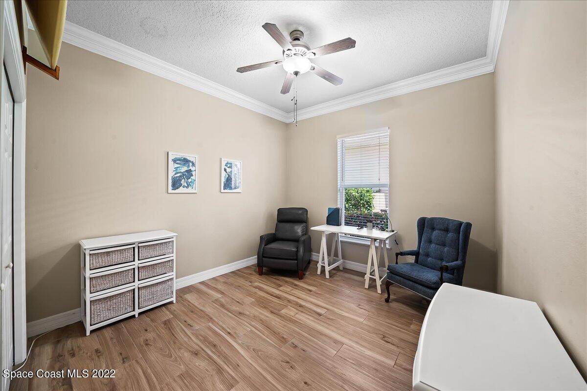 245 Clyde Street Melbourne Beach, FL 32951 - Photo 19 of 47 a bedroom with furniture and wooden floor