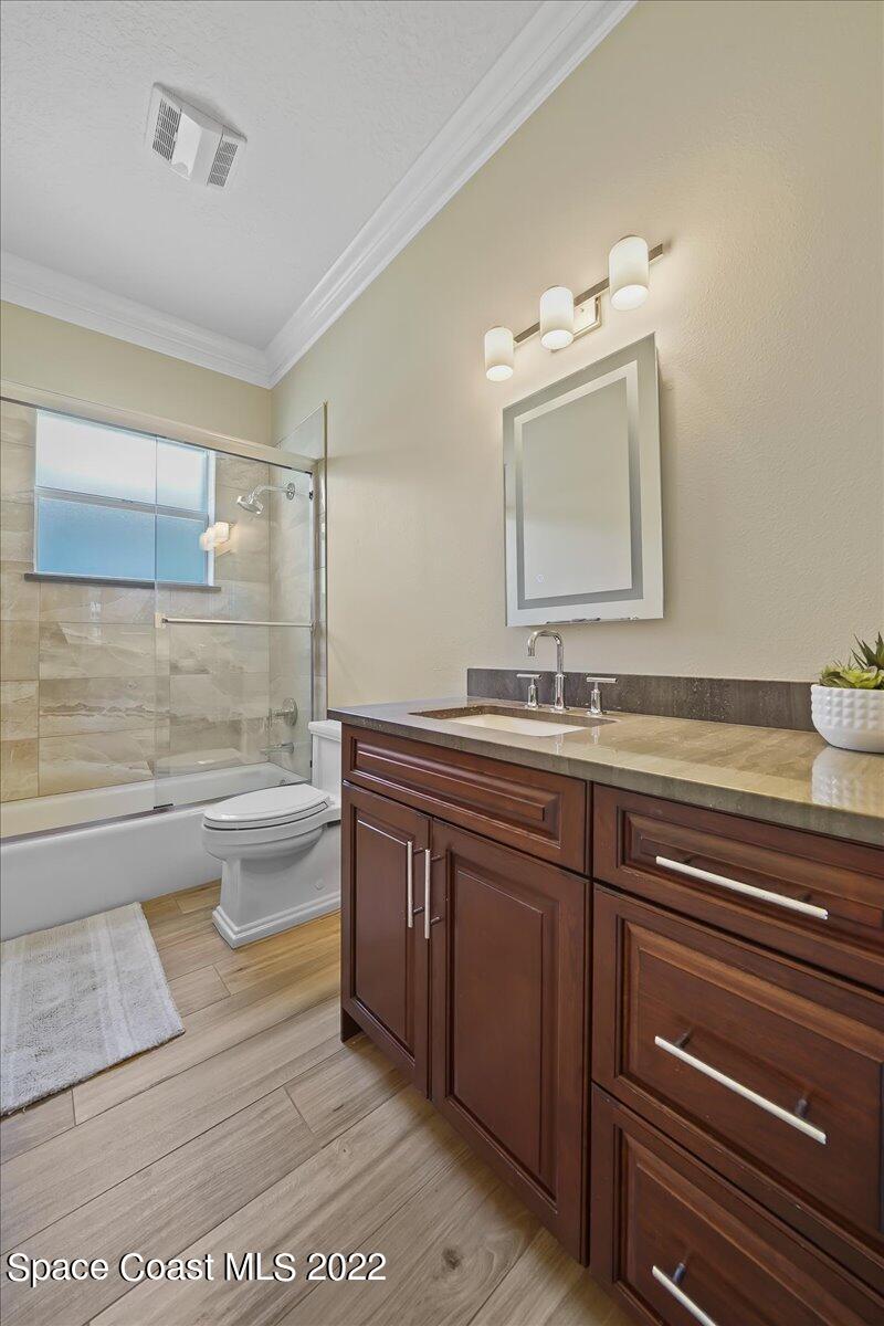 245 Clyde Street Melbourne Beach, FL 32951 - Photo 21 of 47 a bathroom with a bathtub shower sink and toilet