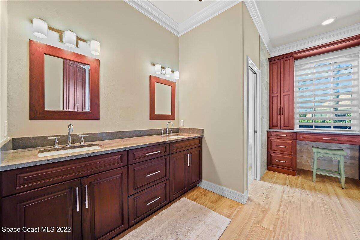 245 Clyde Street Melbourne Beach, FL 32951 - Photo 25 of 47 a spacious bathroom with a granite countertop sink and a mirror
