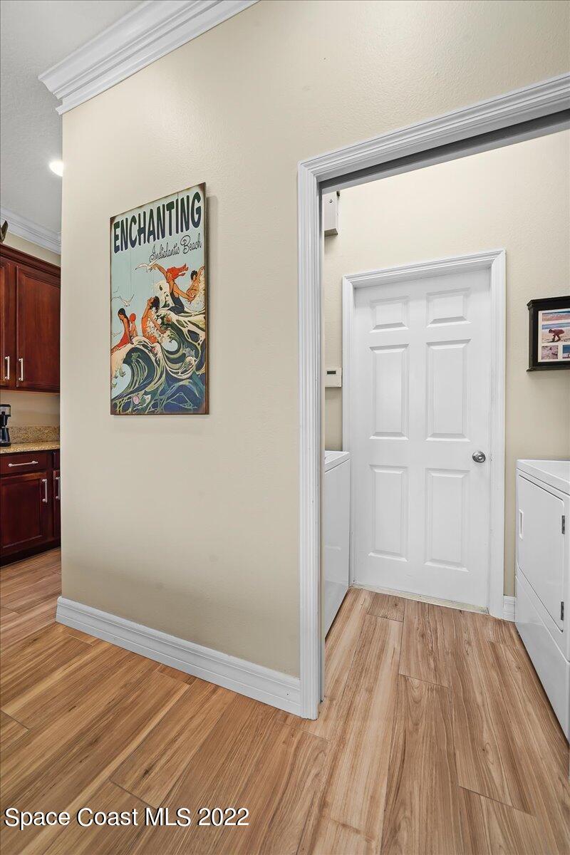 245 Clyde Street Melbourne Beach, FL 32951 - Photo 27 of 47 a view of a hallway with wooden floor and closet