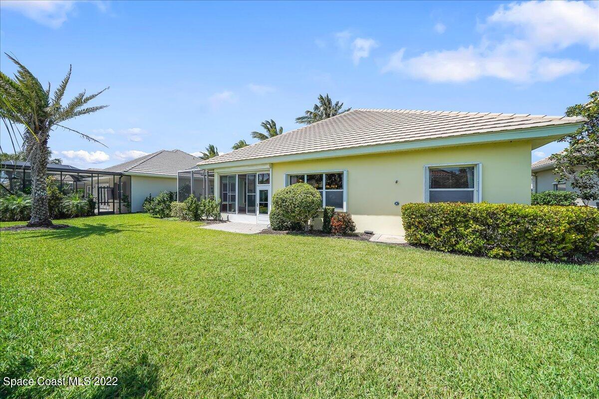 245 Clyde Street Melbourne Beach, FL 32951 - Photo 29 of 47 a front view of house with yard and green space
