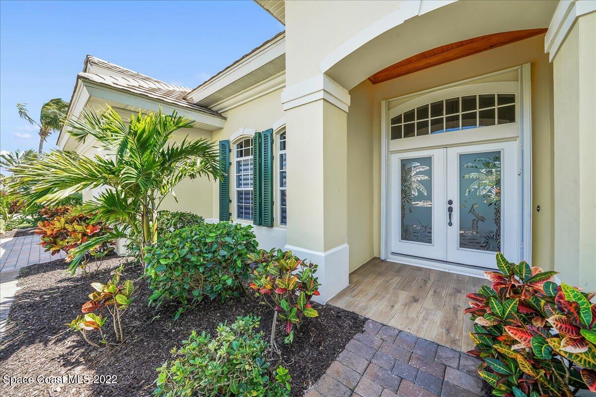245 Clyde Street Melbourne Beach, FL 32951 - Photo 4 of 47 a front view of a house with a yard