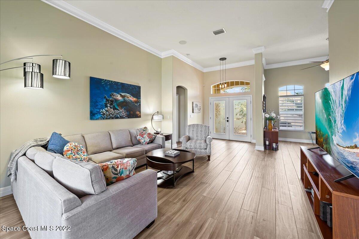 245 Clyde Street Melbourne Beach, FL 32951 - Photo 7 of 47 a living room with furniture and a flat screen tv