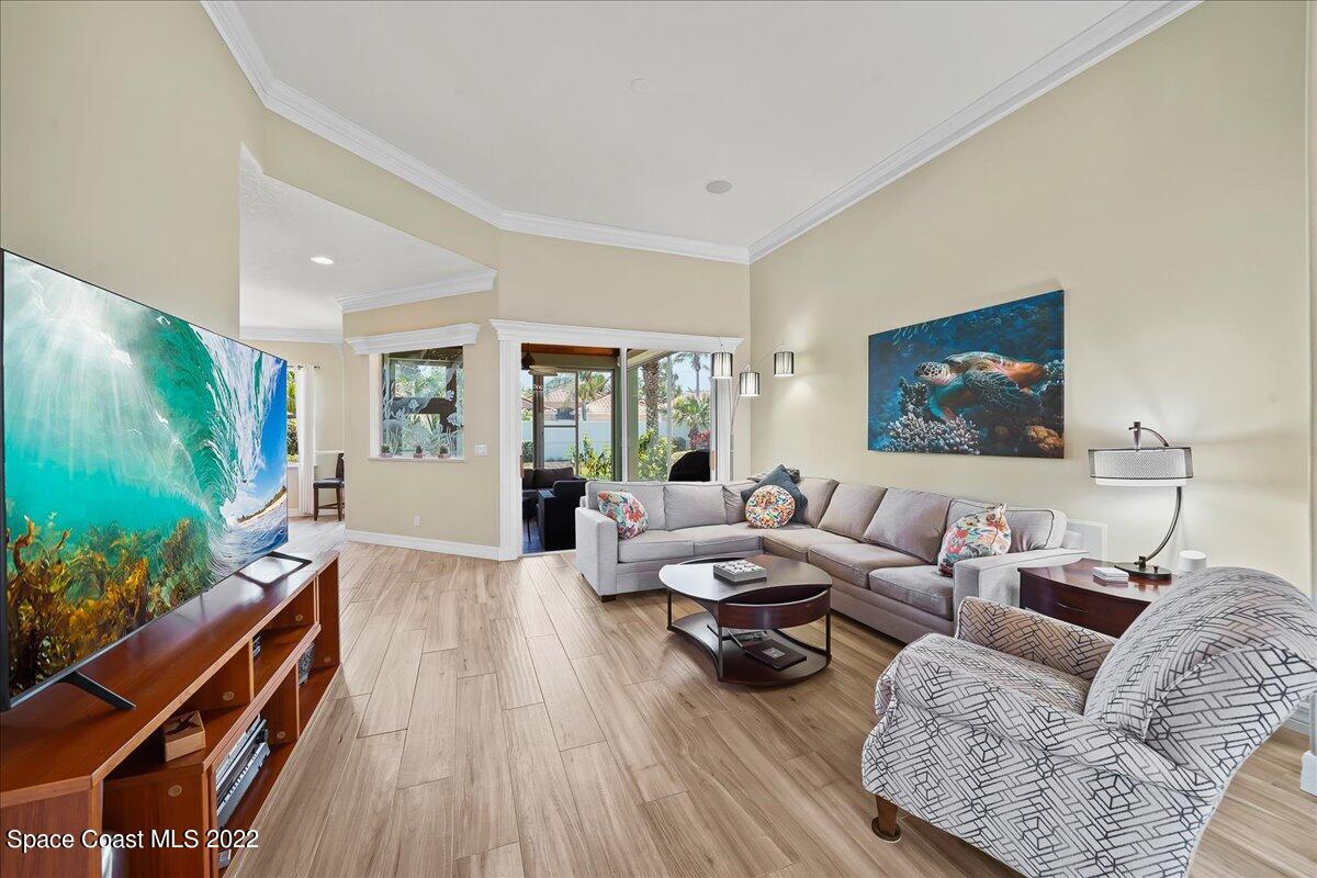 245 Clyde Street Melbourne Beach, FL 32951 - Photo 8 of 47 a living room with furniture and a flat screen tv