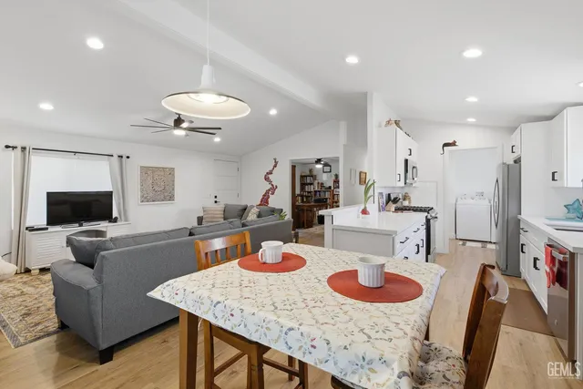 a view of a dining room with furniture and a kitchen