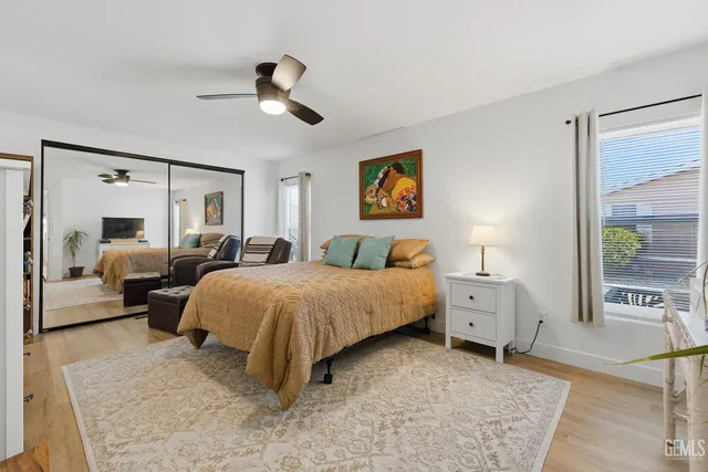 a spacious bedroom with a bed and ceiling fan