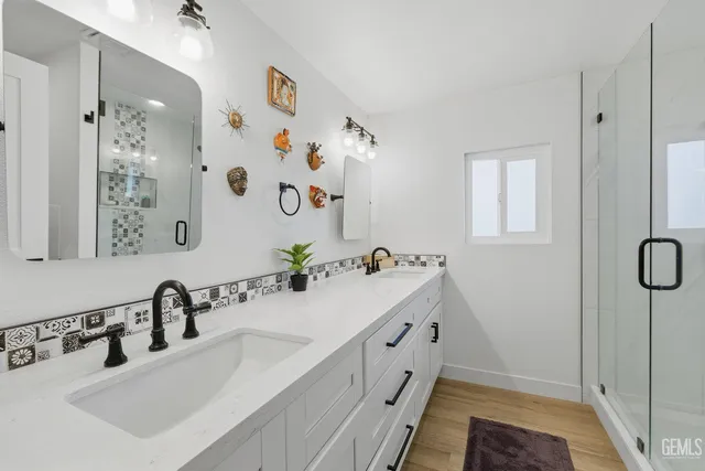 a bathroom with a double vanity sink and a mirror