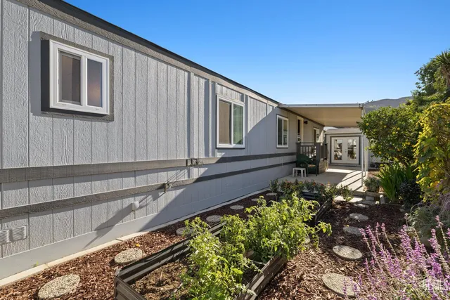 a view of a house with a wooden fence