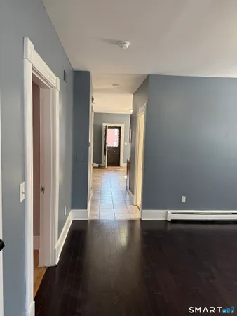a view of a hallway with wooden floor