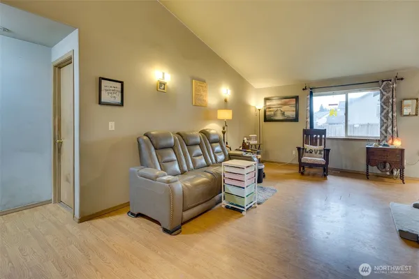 a living room with furniture and a wooden floor