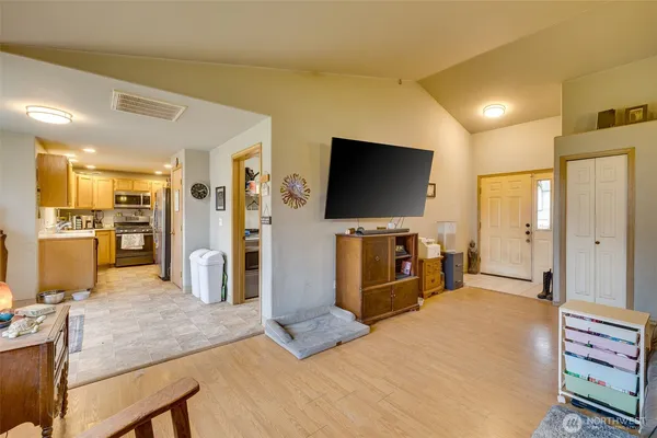 a large bedroom with a bed and a flat screen tv